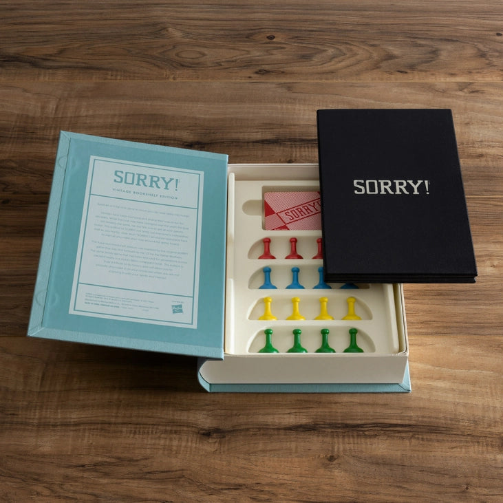 Open Sorry! game box with pieces on a wooden surface