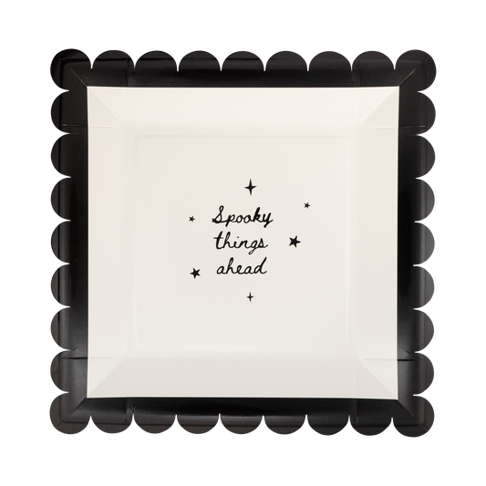 square paper plates with 'Spooky things ahead' text and black scalloped border on a white background
