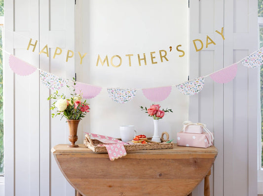Spring table styled with striped floral dinner napkins, pastel decor, and Mother’s Day banner in Toronto