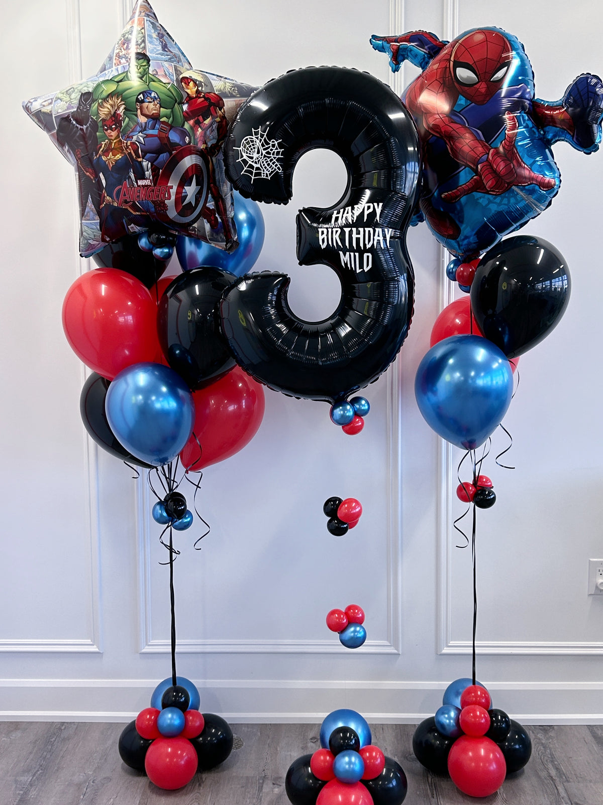 Superhero birthday balloon package with personalized number, character balloons and red, blue + black balloons in Toronto.