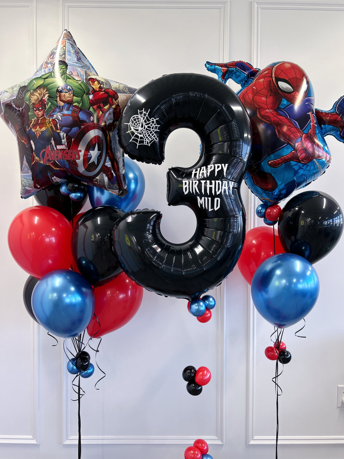 Red, blue + black superhero birthday balloons with Spider-Man, Avengers and personalized number balloon in Toronto.