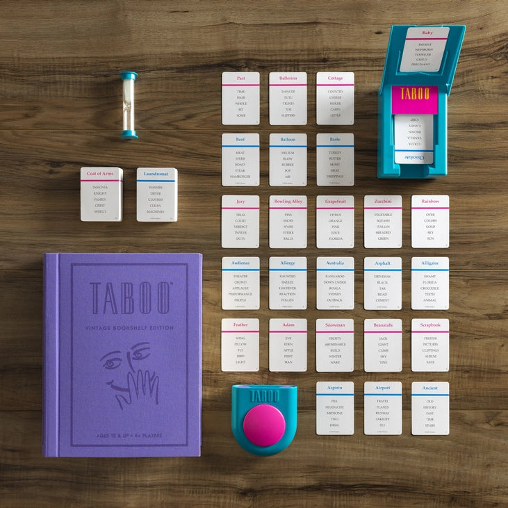 Taboo game components on a wooden surface