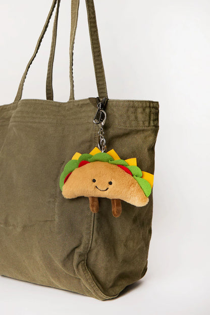 Taco plush keychain charm clipped onto tote bag available at our Toronto party shop