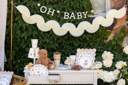 Neutral teddy bear baby shower table setup with gold accents and paper plates, cups, and décor in Toronto.