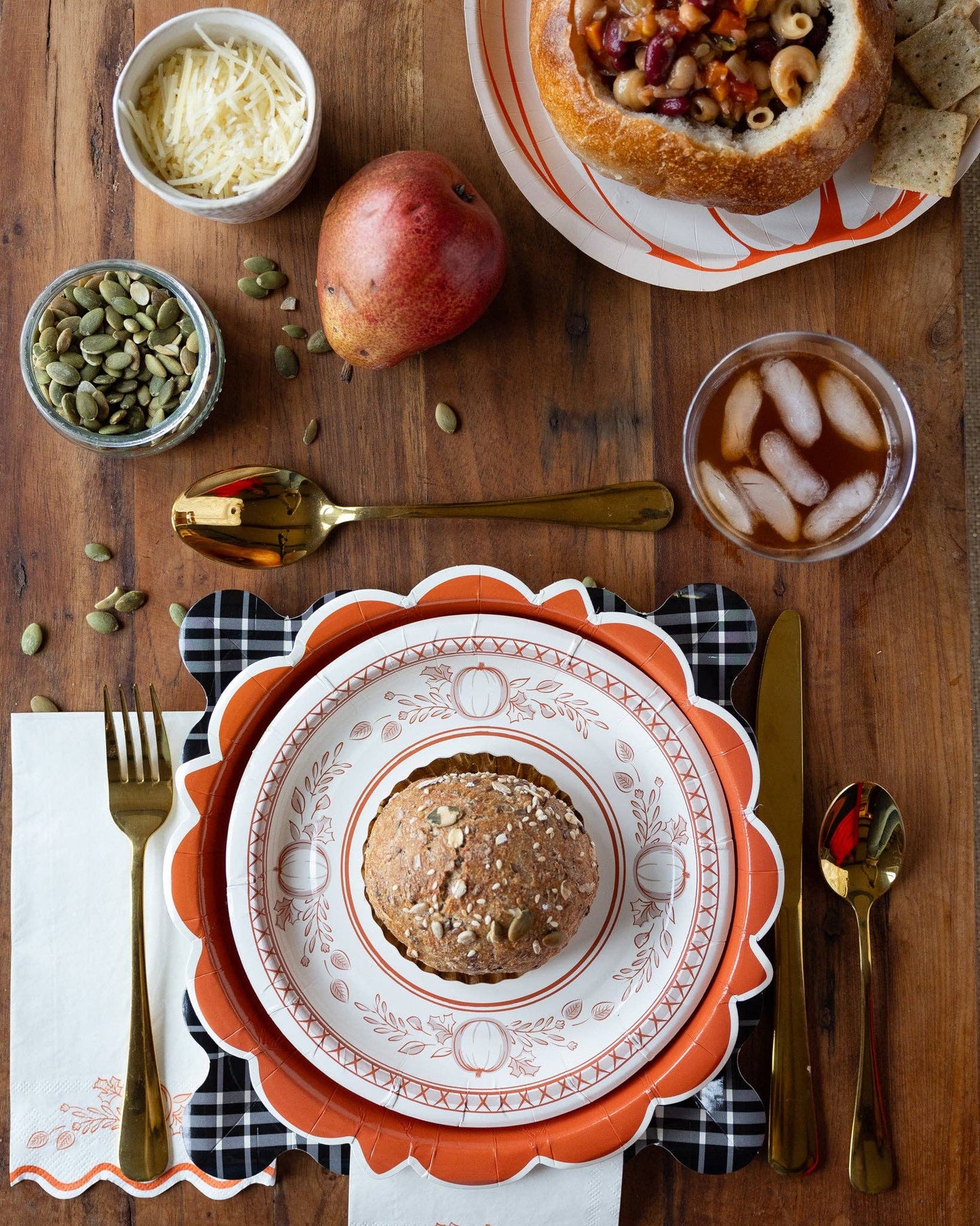 Thanksgiving table setting with pumpkin dessert plate and fall decor.