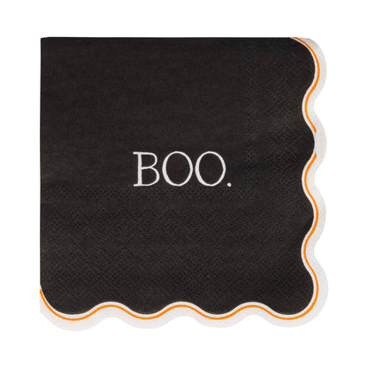 Black cocktail napkin with white “BOO.” text and scalloped edges, available at our Toronto party shop.
