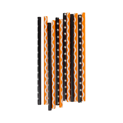 Set of Halloween-themed straws with black, orange, and white patterns on a white background