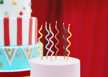 Colourful curl birthday candles styled on a modern birthday cake available in Toronto and shipping across Canada