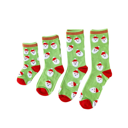 Set of four green socks with Santa Claus faces and red accents on a white background