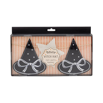 Packaged witch hats with a star-shaped label on a striped background