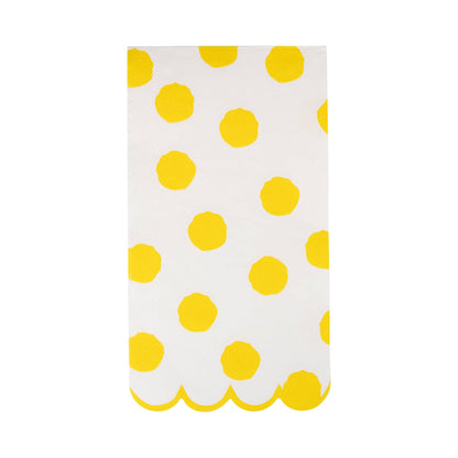 White dinner napkins with bright yellow polka dots and a yellow scalloped edge.