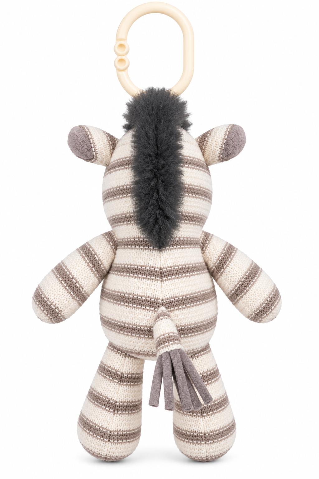 Back view of cream and taupe knitted zebra stroller plush showing its dark grey fluffy mane, striped body, tassel tail and ivory attachment ring.
