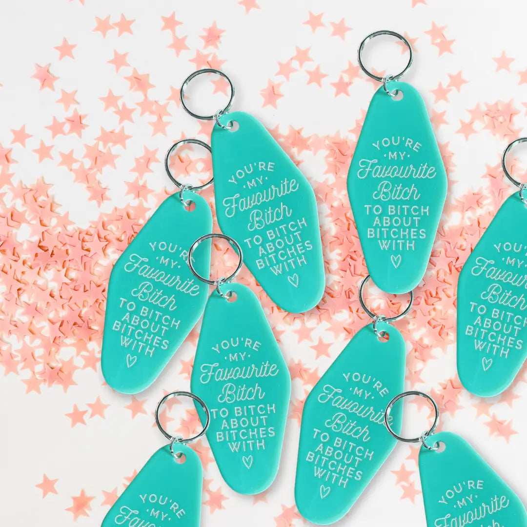 teal motel keychains with confetti background