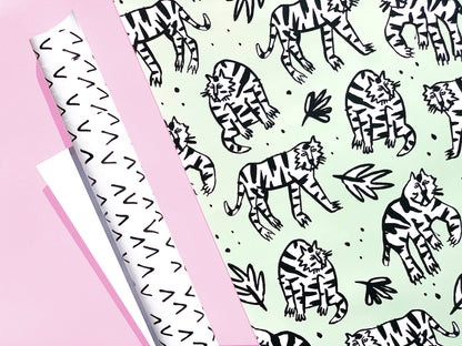 mint wrapping paper with black and white tiger illustrations