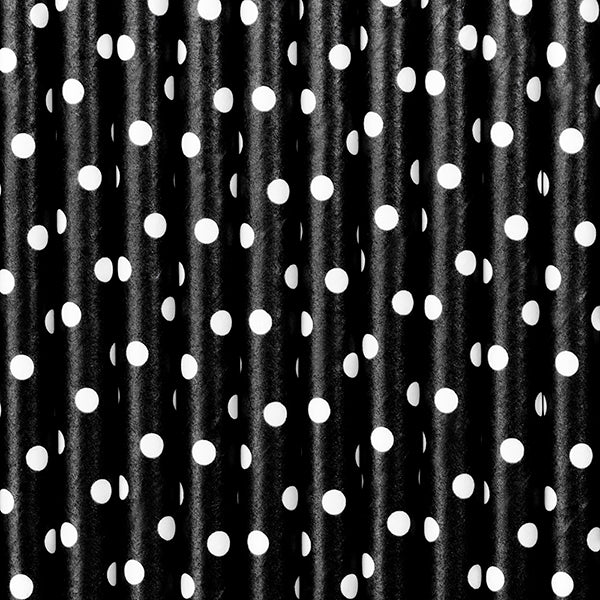 up close shot of black and white dotted paper straws