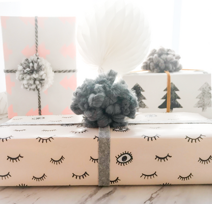 presents wrapped in blush eyes gift wrap sheets