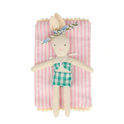 mini bunny with bathing suit on striped blanket