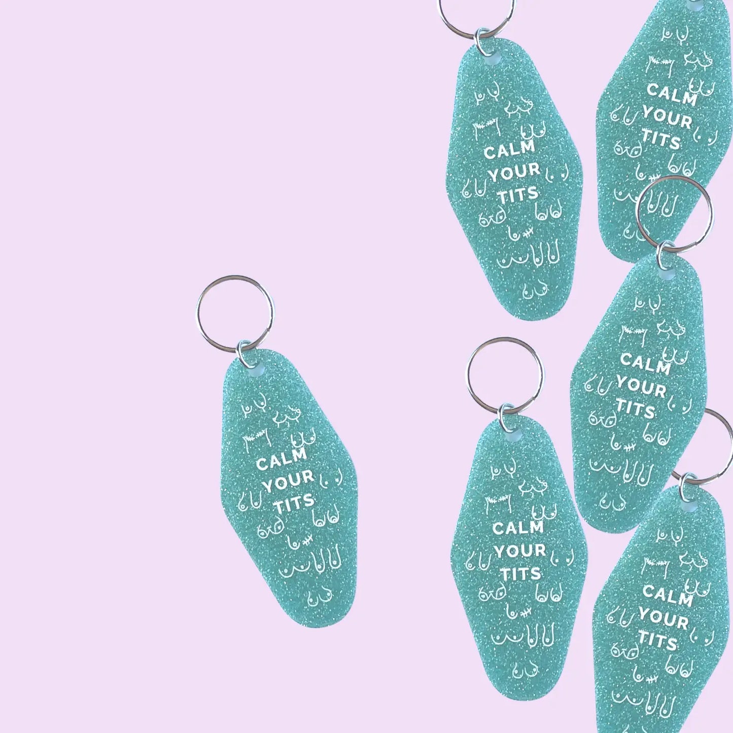 aqua hotel style keychain with white "calm your tits" quote