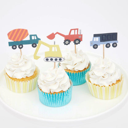 four cupcakes with construction truck cupcake toppers