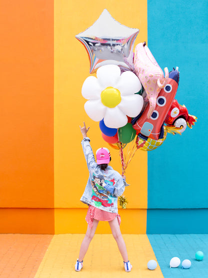 young girl holding a mixed bundle of helium balloons including foil rocket ship, foil star and foil daisy