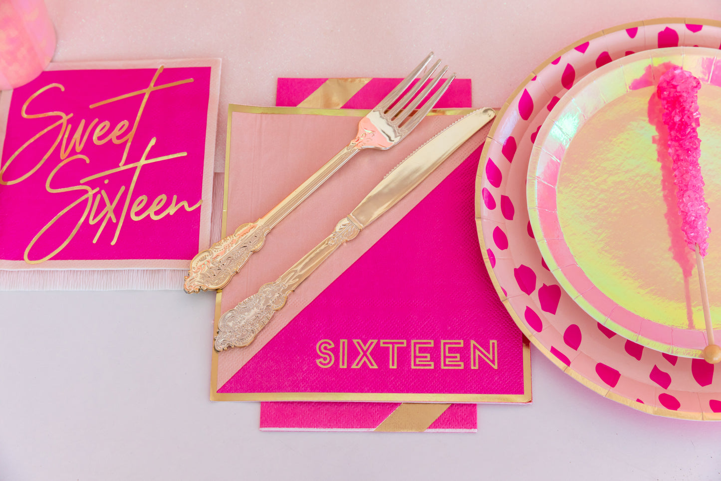 sweet sixteen party decor with napkins, plates and cutlery