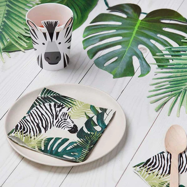 Jungle-inspired party table featuring zebra paper cup and tropical leaf napkins for kids’ celebrations, shipped anywhere in Canada.