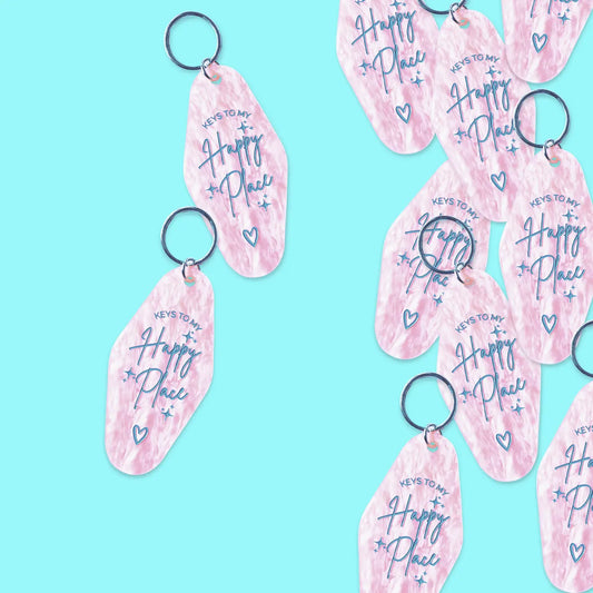Pink marbled acrylic “Keys to My Happy Place” keychain, available in Toronto and shipping across Canada.