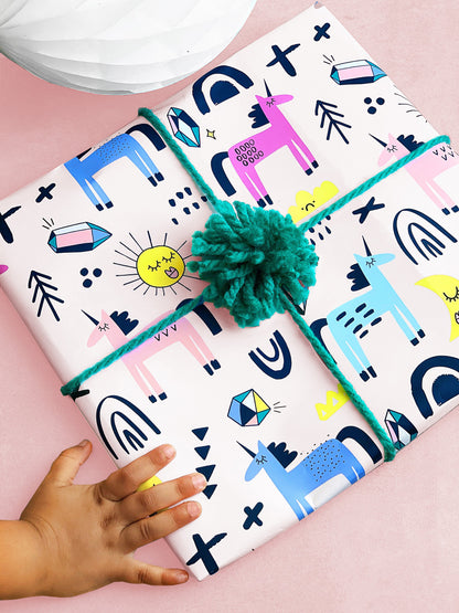 a gift wrapped in unicorn wrapping paper by hooray all day