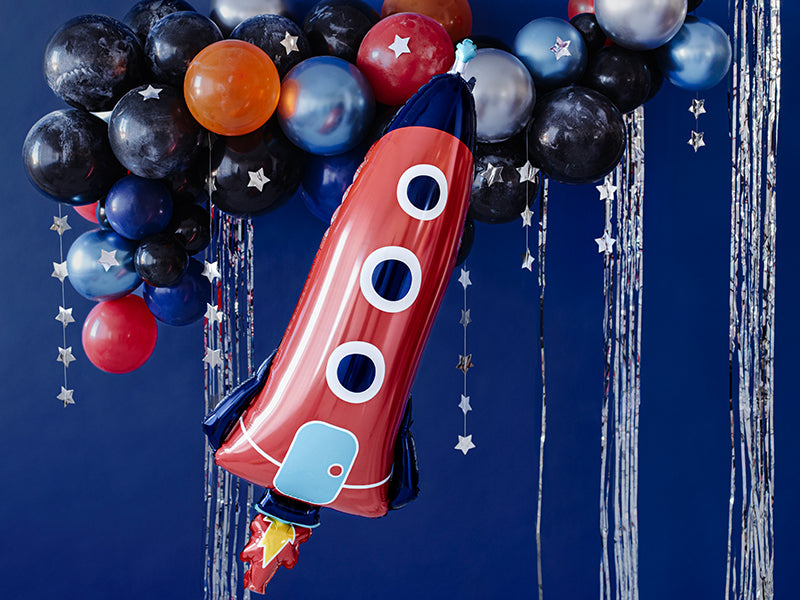 space themed party inspo with balloon garland and vintage rocket ship foil